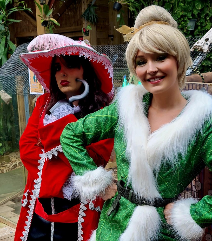 Two people dressed as Captain Hook and Tinkerbell posing for the camera